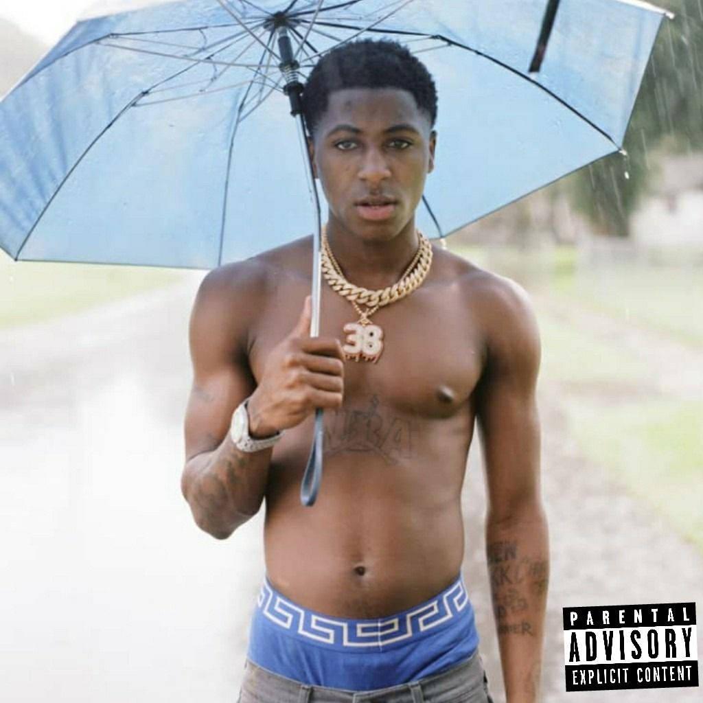 NBA Youngboy ducks under a blue umbrella in style — 1024x1024 wallpaper