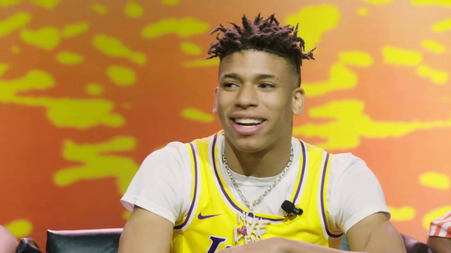 Nle Choppa posing in front of a Lakers backdrop — 1920x1080 wallpaper