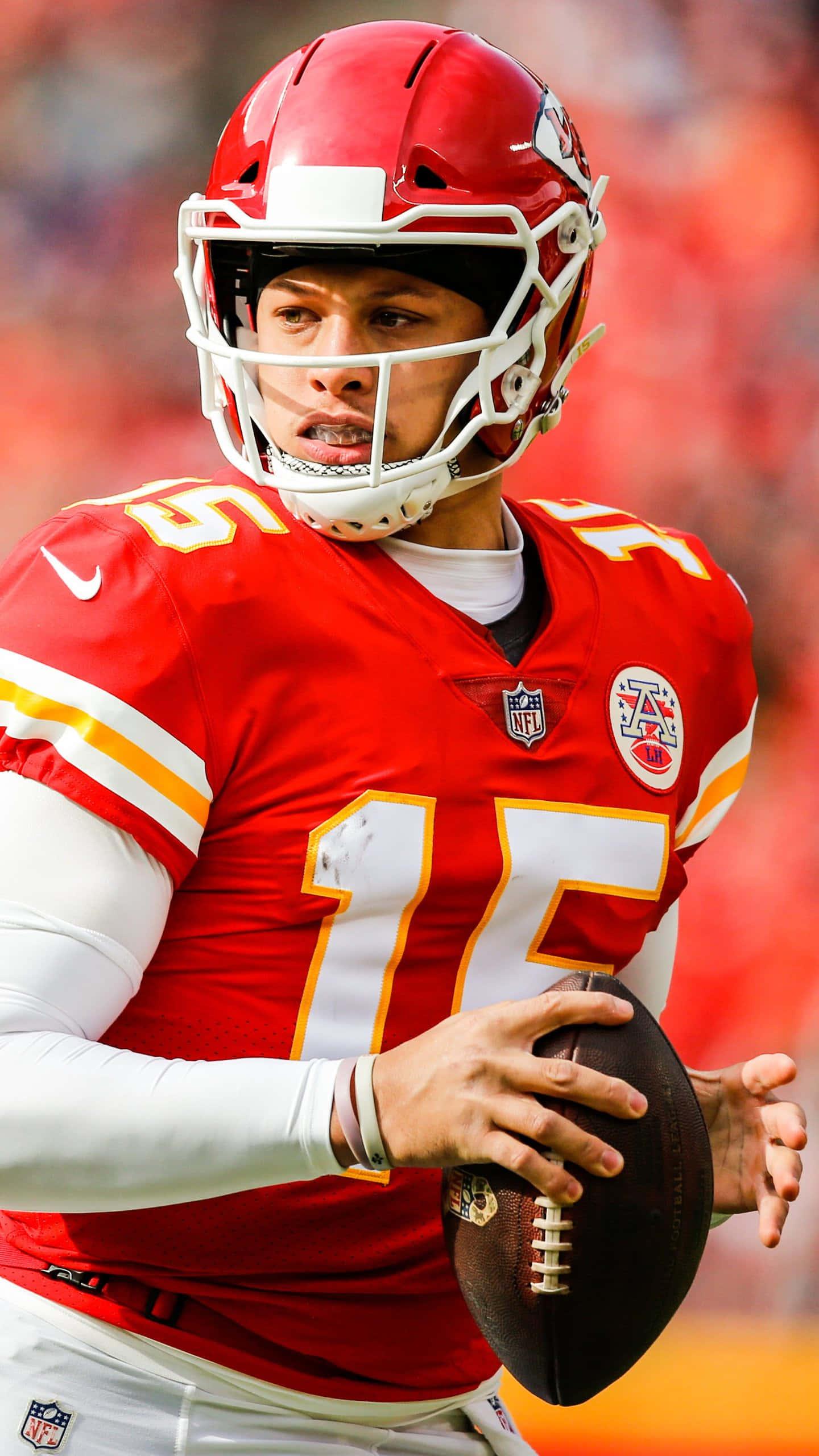 Patrick Mahomes standing strong on the football field — 1440x2560 wallpaper