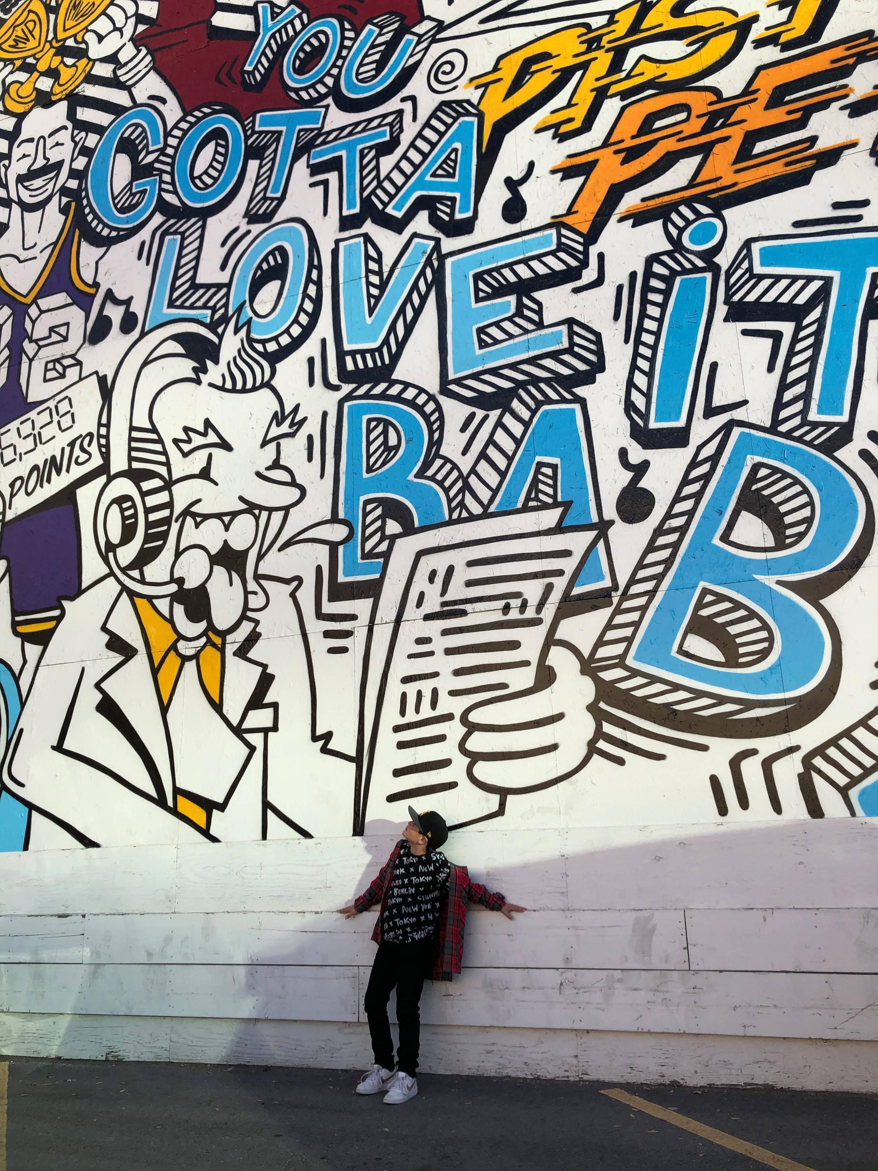 Person Beside Cool Graffiti — 3024x4032 wallpaper