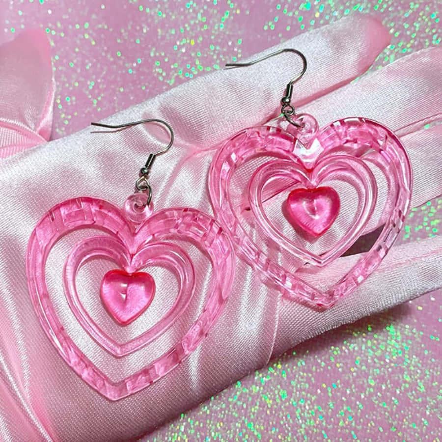 pink heart shaped earrings on a pink silk — 900x900 wallpaper