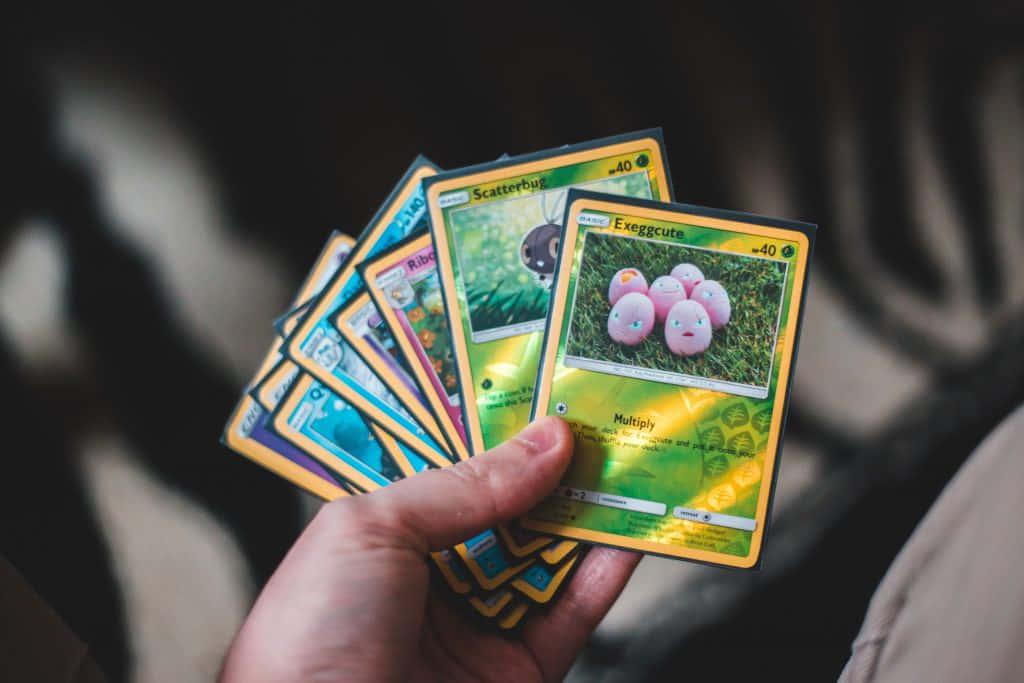 pokemon cards in a hand holding them up — 1024x683 wallpaper