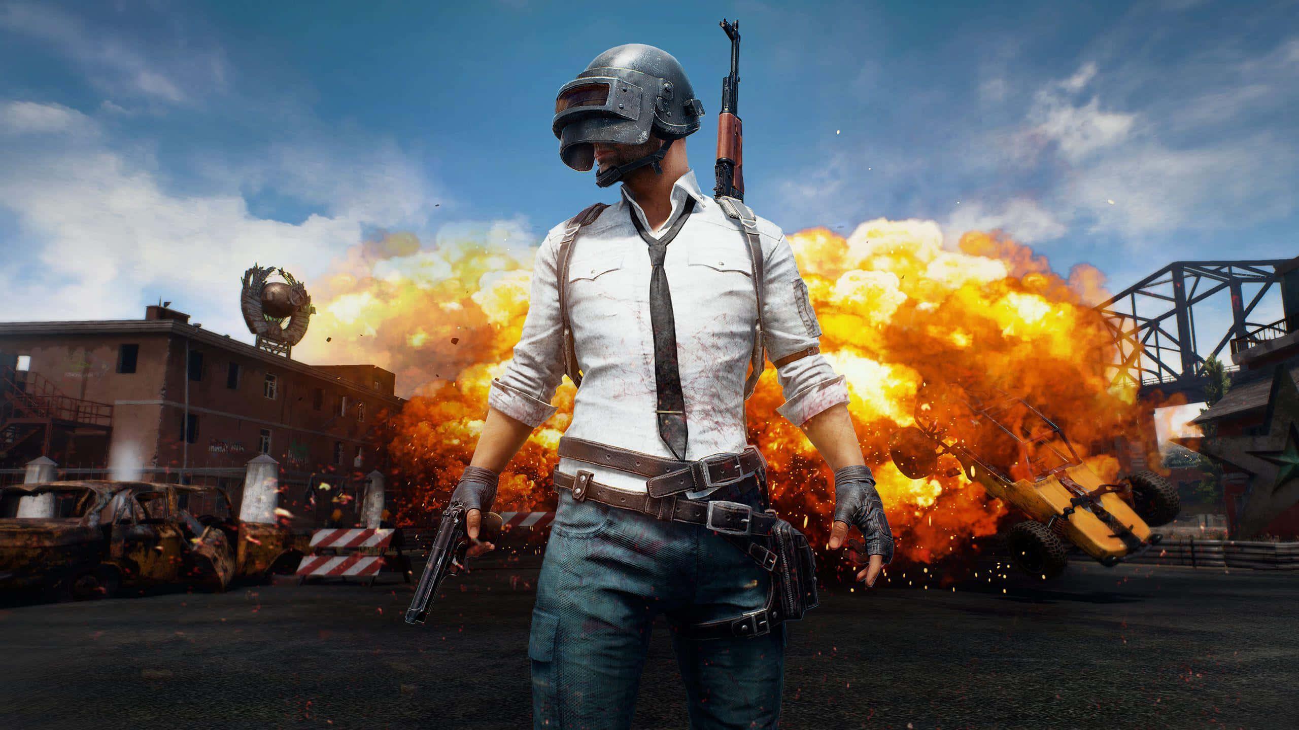 pubg mobile - a man standing in front of an explosion — 2560x1440 wallpaper