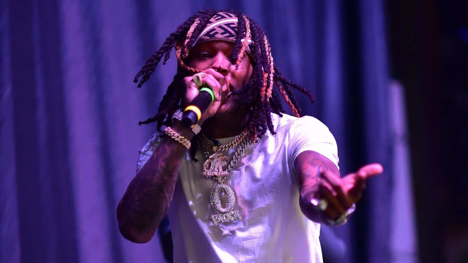 Rapper King Von showcasing his distinct style and charisma — 1600x900 wallpaper