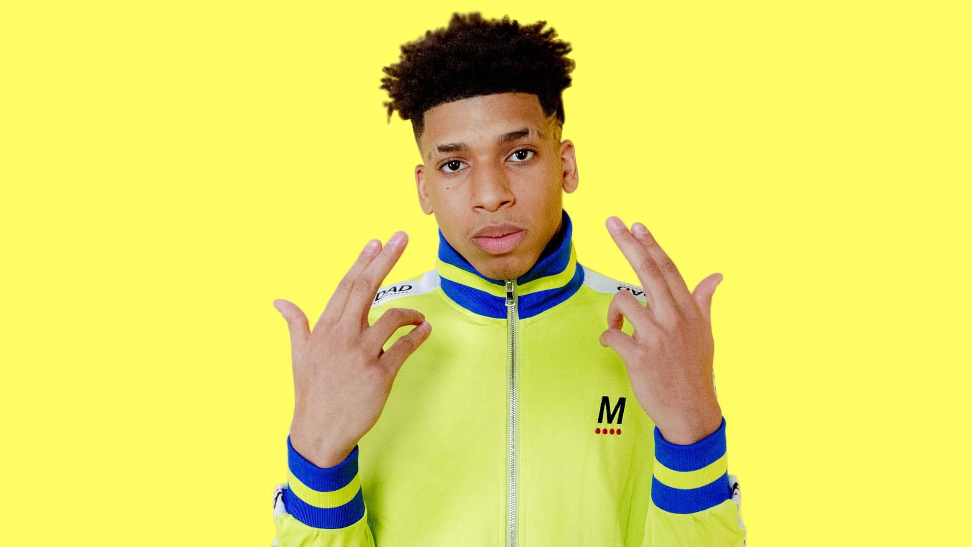 Rapper NLE Choppa stands ready with a microphone. — 1920x1080 wallpaper