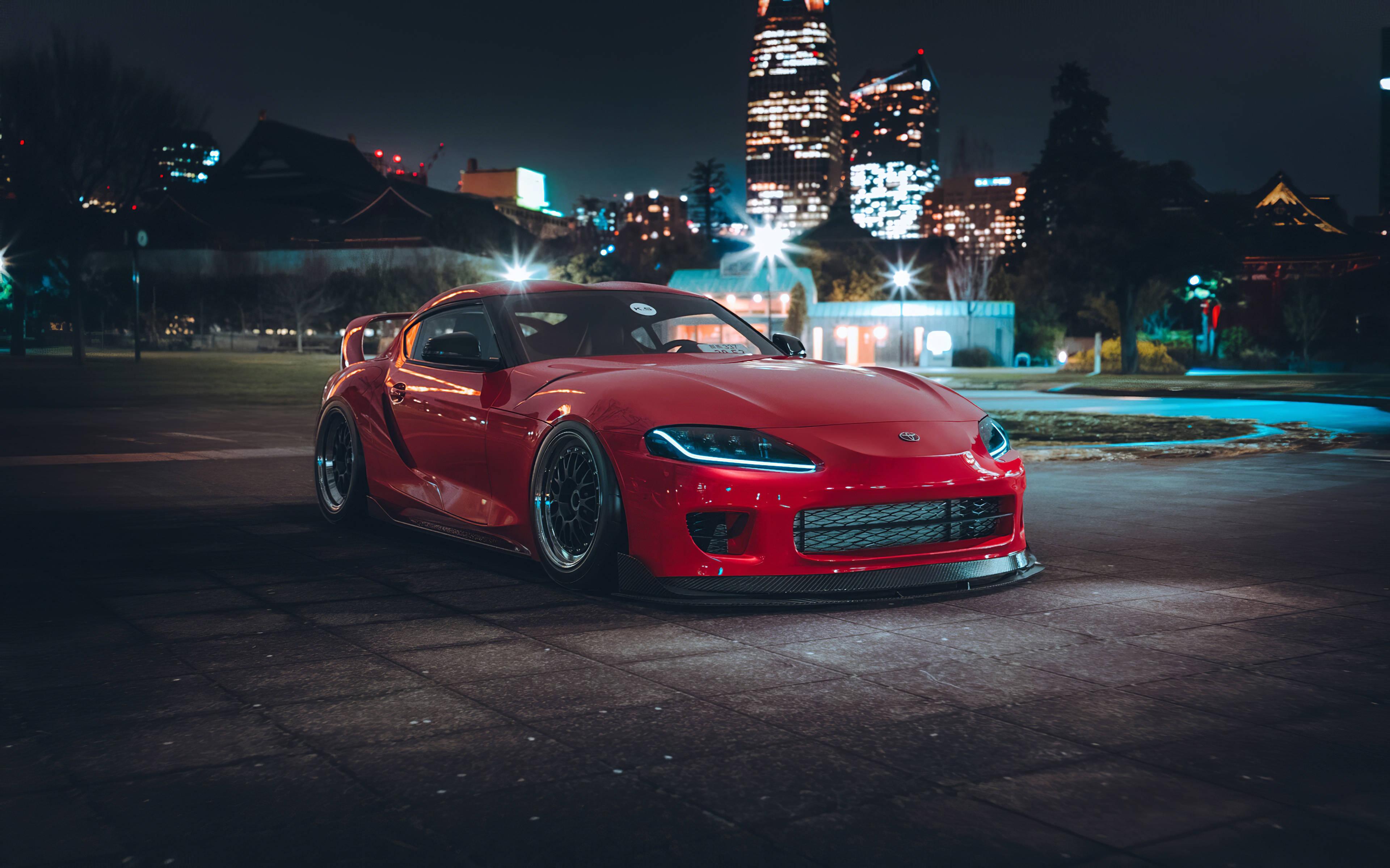 Red Toyota Supra Parked Near Cityscape — 3840x2398 wallpaper