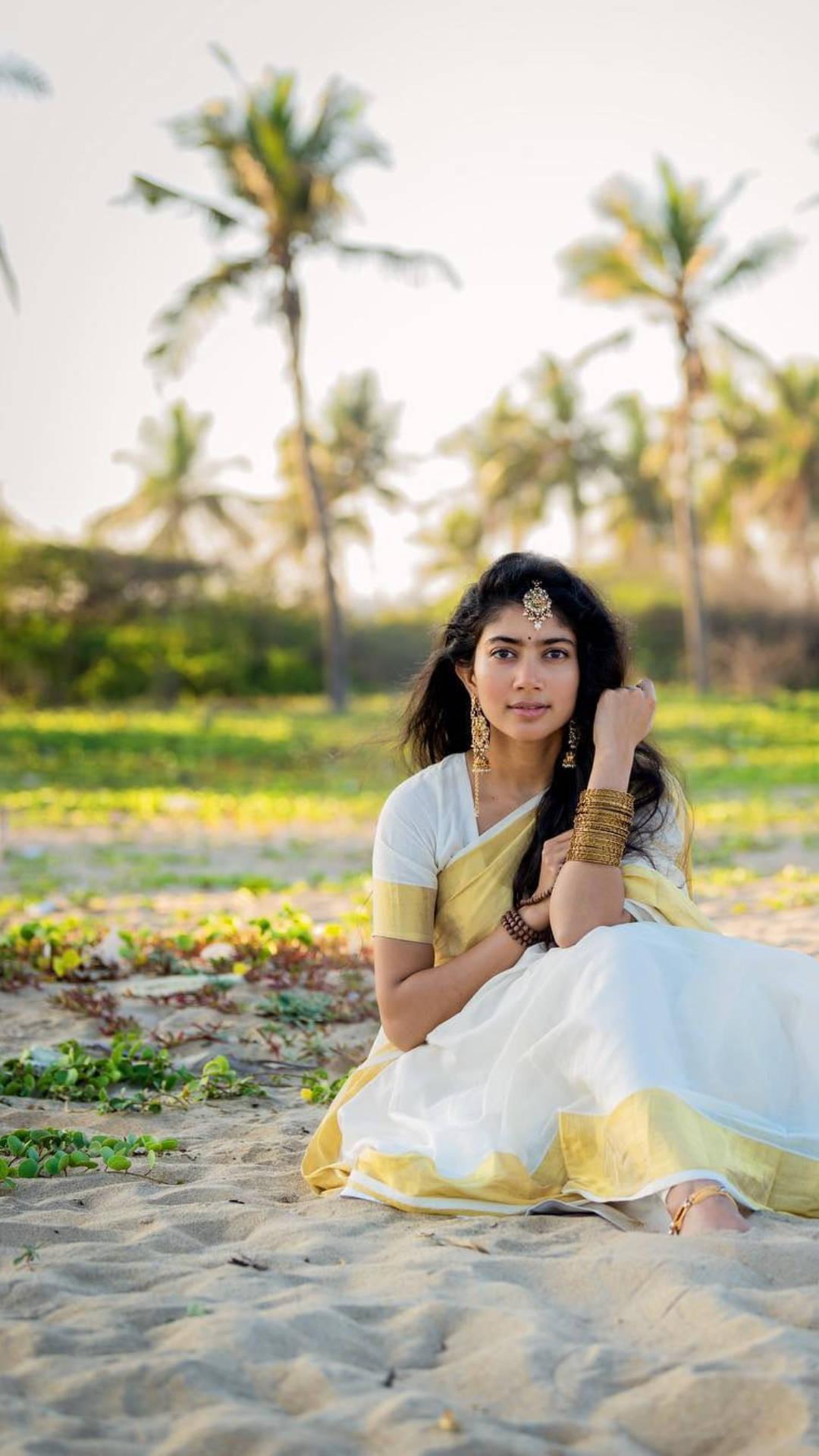 Sai Pallavi Seated On The Sand — 1080x1920 wallpaper