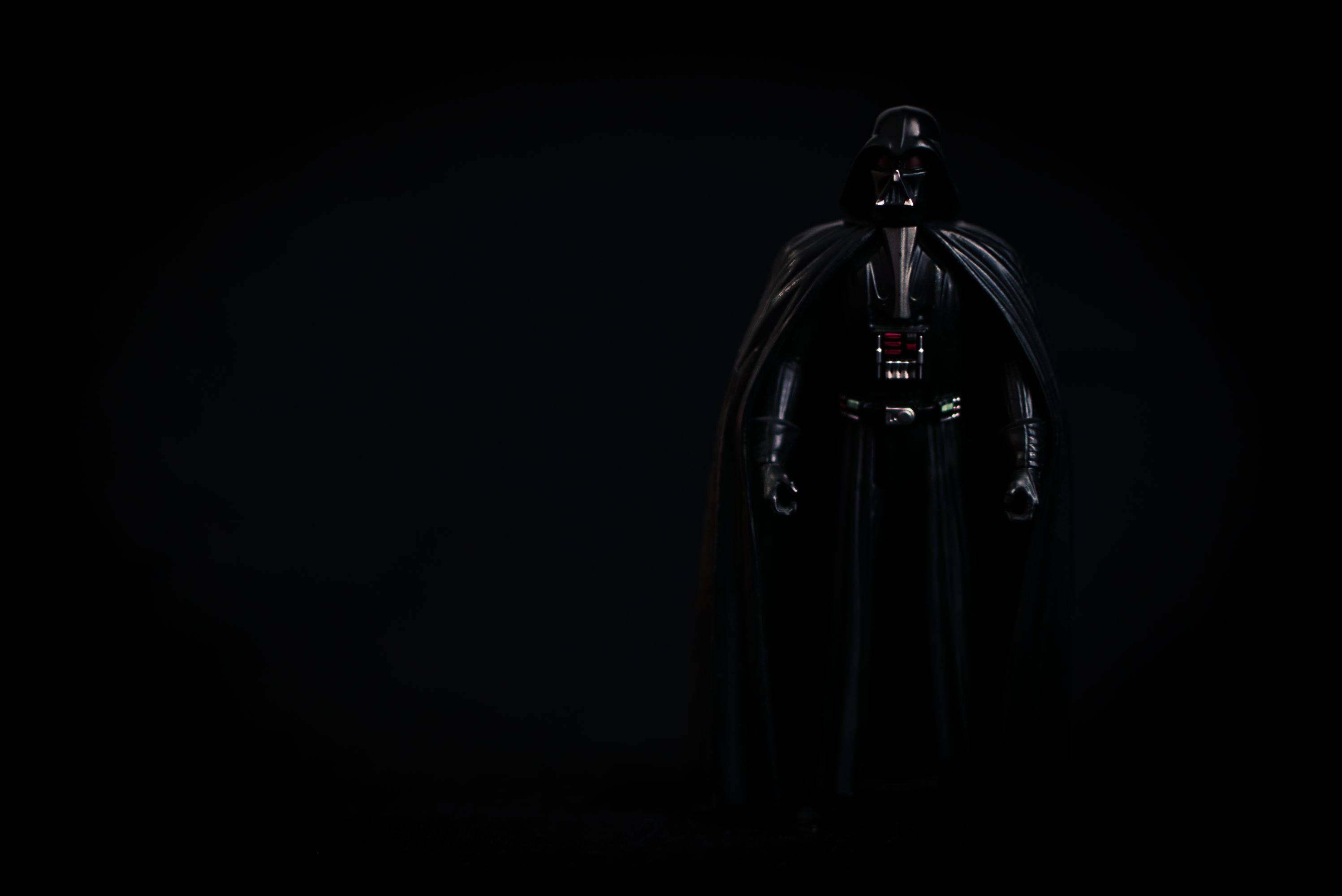 Sith Lord Darth Vader looms in the darkness