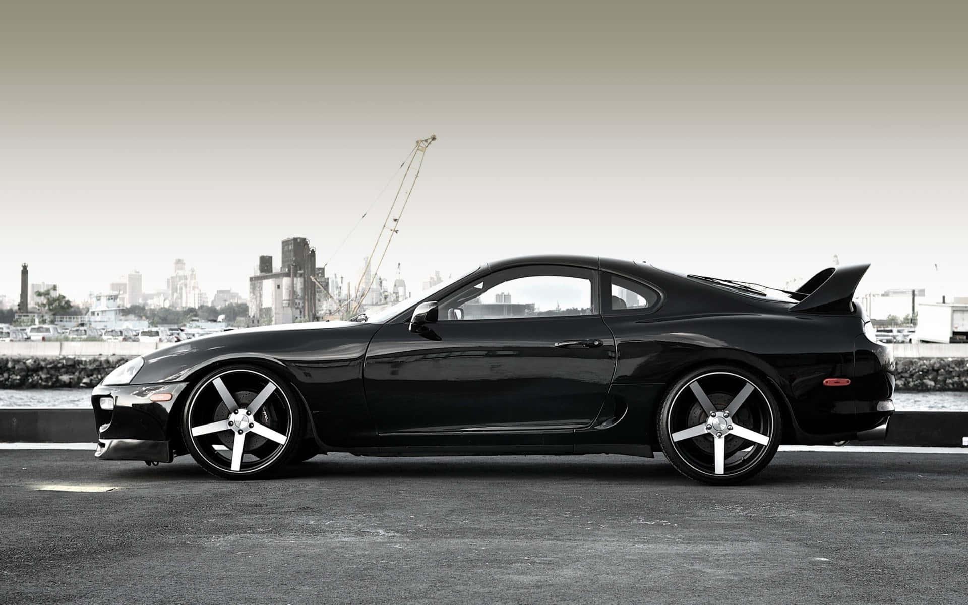 Sleek silver Toyota Supra parked on a racetrack — 1920x1200 wallpaper