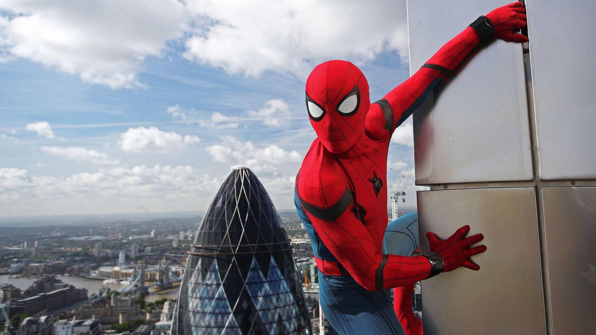 Spiderman swinging in front of the Gherkin Tower