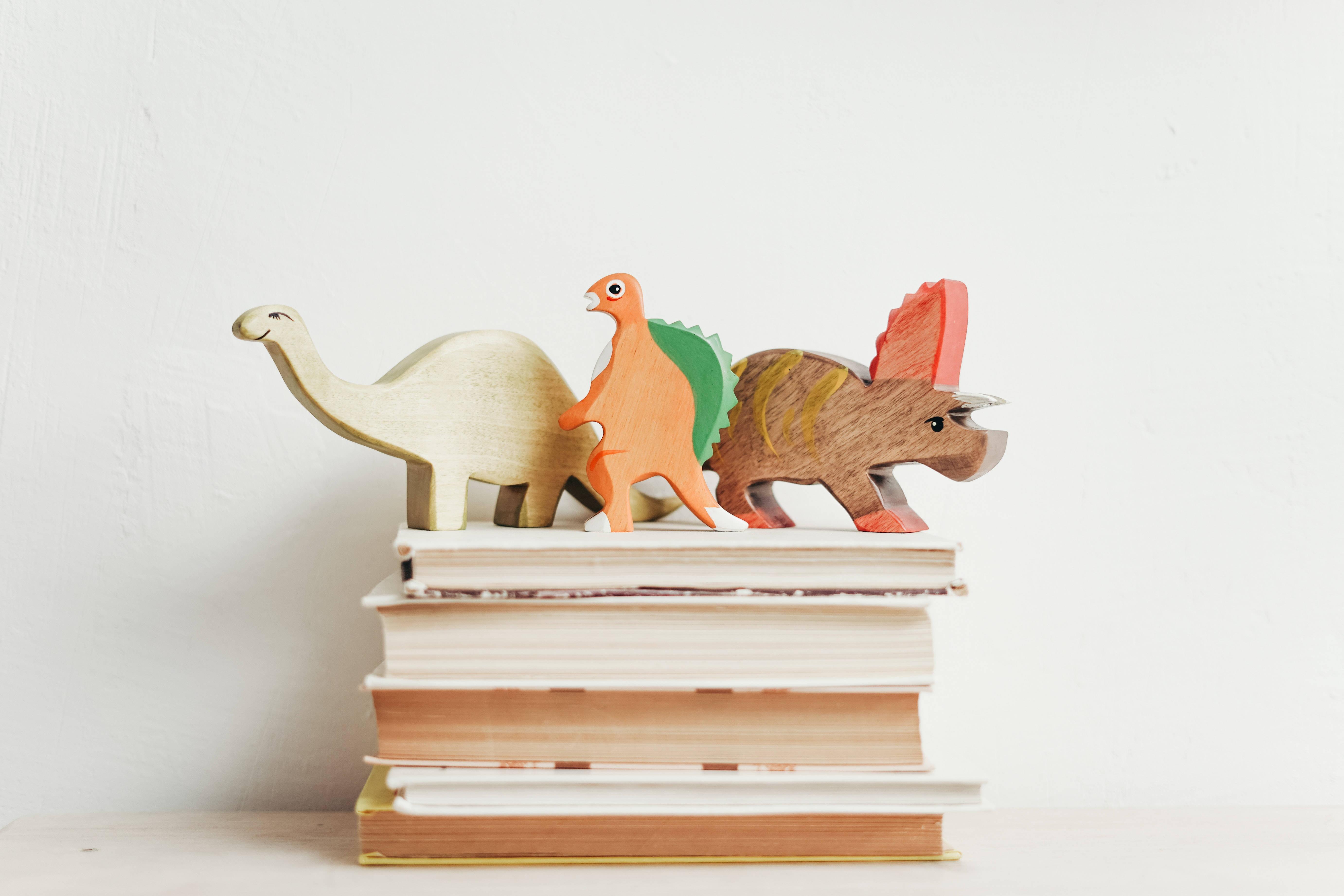 Study Motivation Dinosaur Figurines on Books — 5527x3685 wallpaper