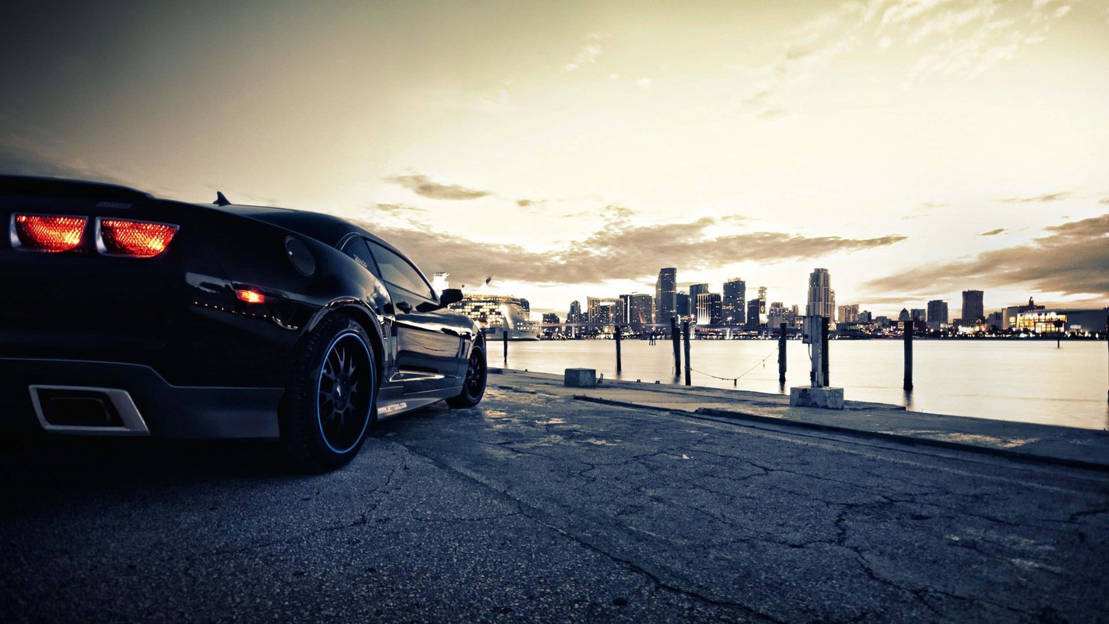 Stunning Red Sports Car on Night Road — 3840x2160 wallpaper