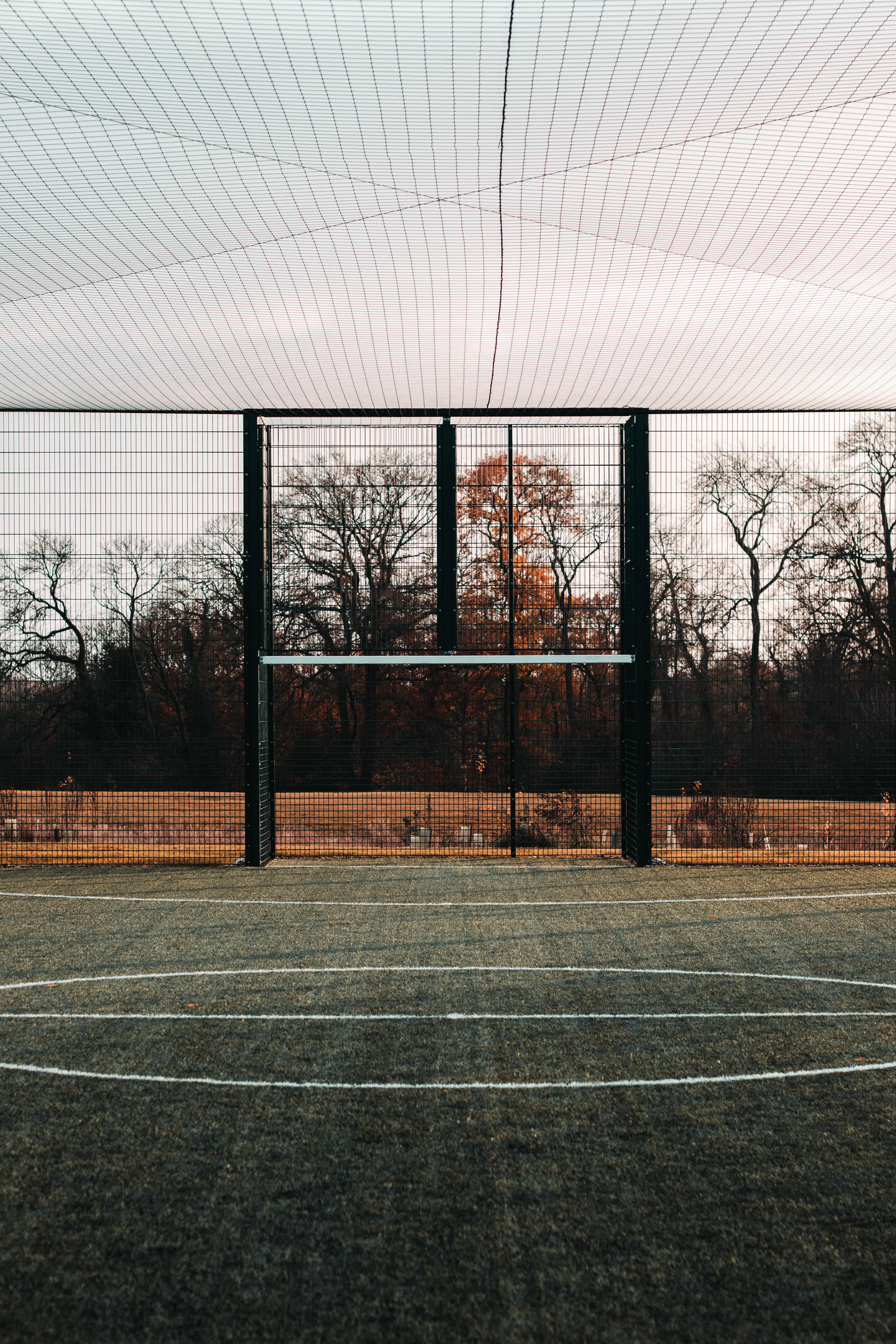 Surrounded by a sense of anticipation, the football field awaits its challengers. — 3944x5916 wallpaper