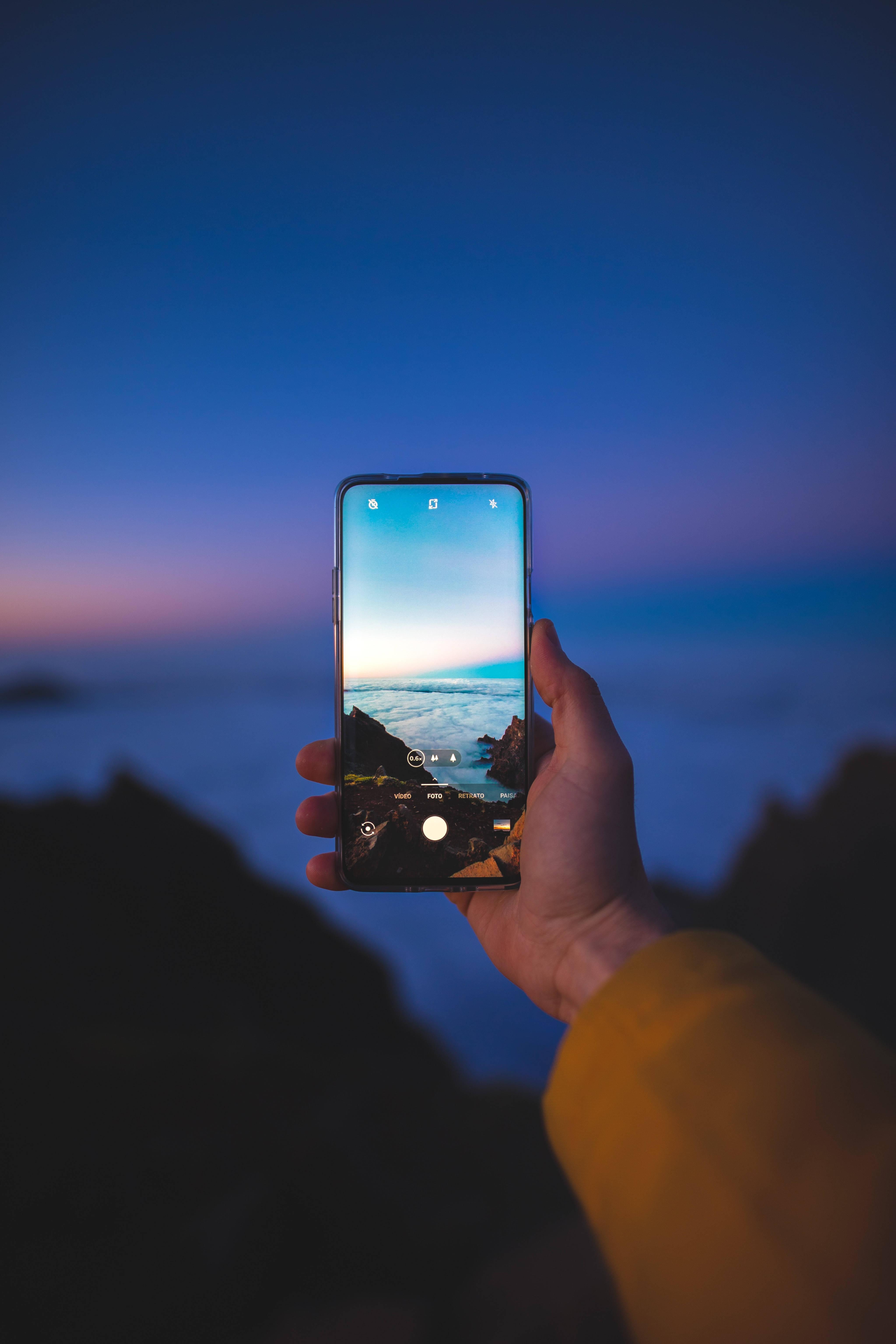 Taking Seaside Photo Using Phone — 4095x6143 wallpaper