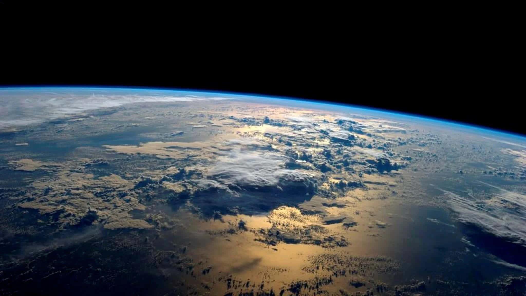 Thick Clouds Over Earth Background — 2048x1152 wallpaper
