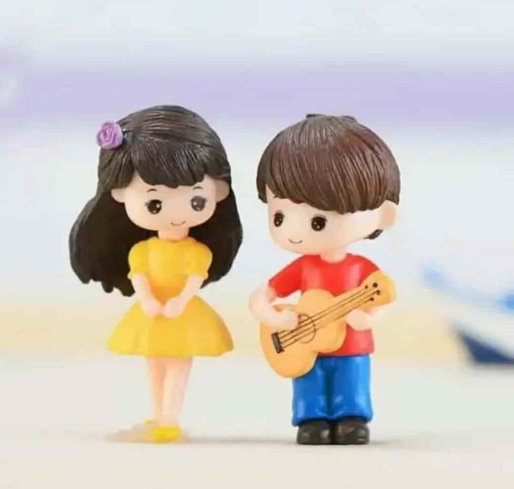two figurines of a boy and girl playing guitar — 1011x962 wallpaper