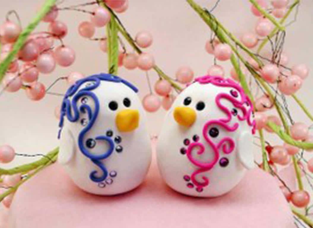 two penguins sitting on top of a pink cake — 1055x768 wallpaper