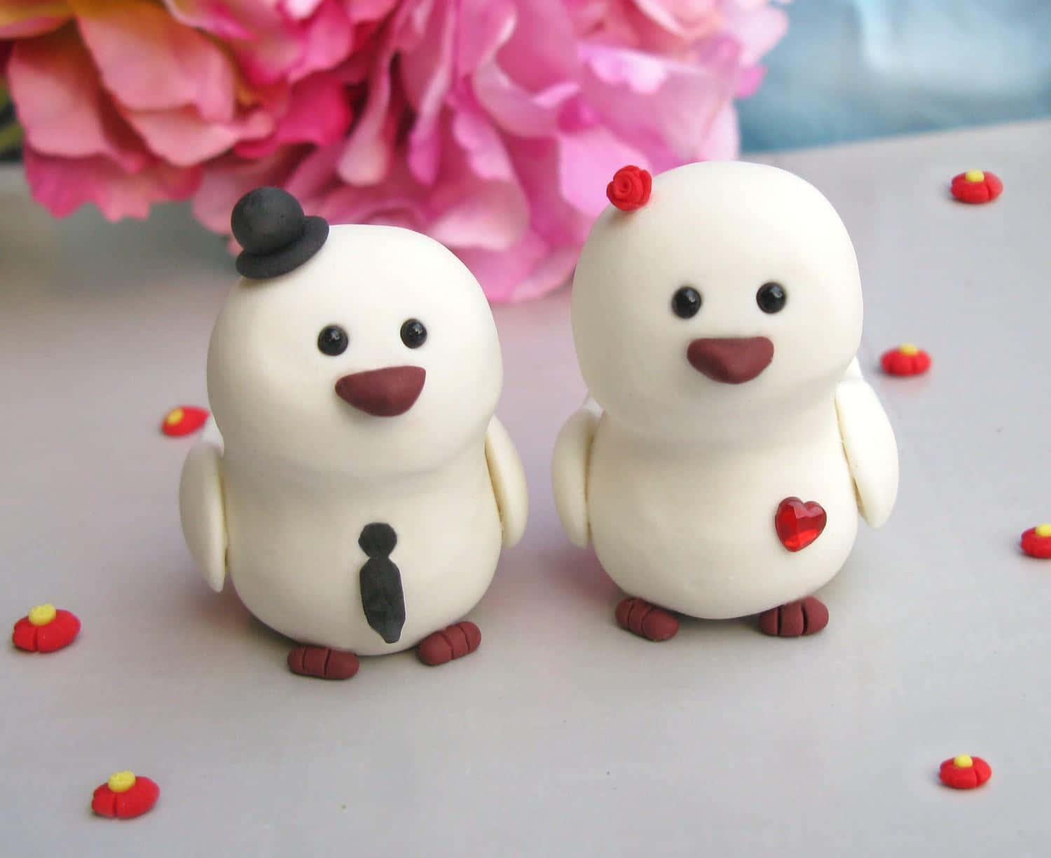 two white wedding cake toppers with a bow on them — 1500x1224 wallpaper