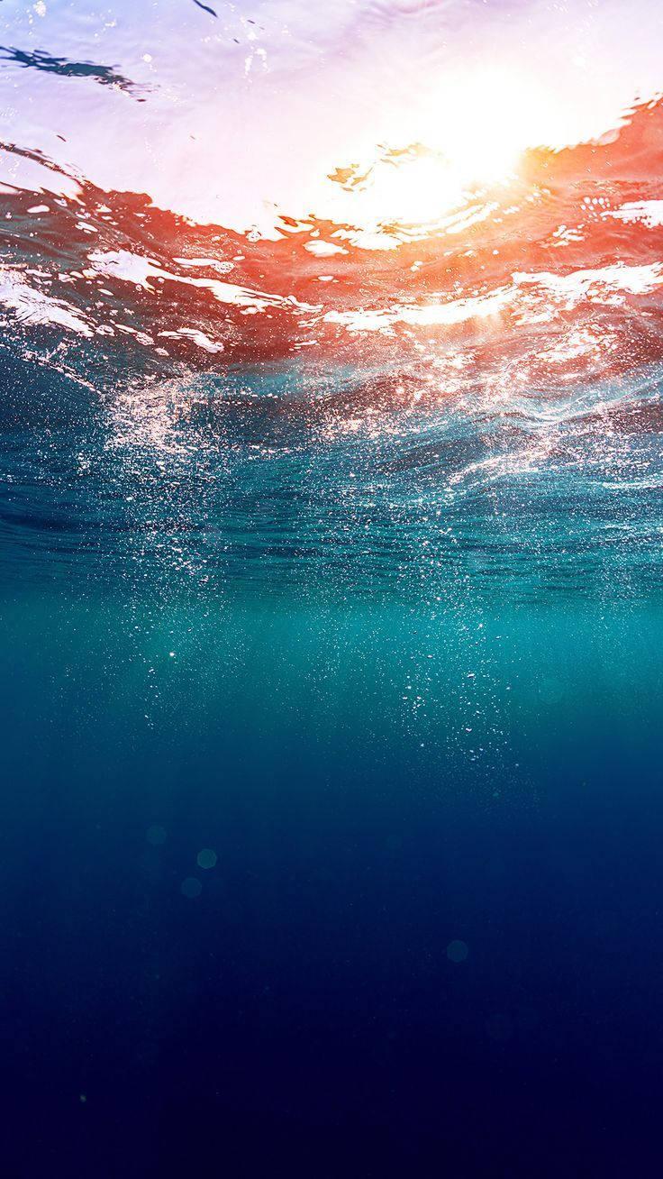 Underneath Ocean Surface Phone — 736x1308 wallpaper