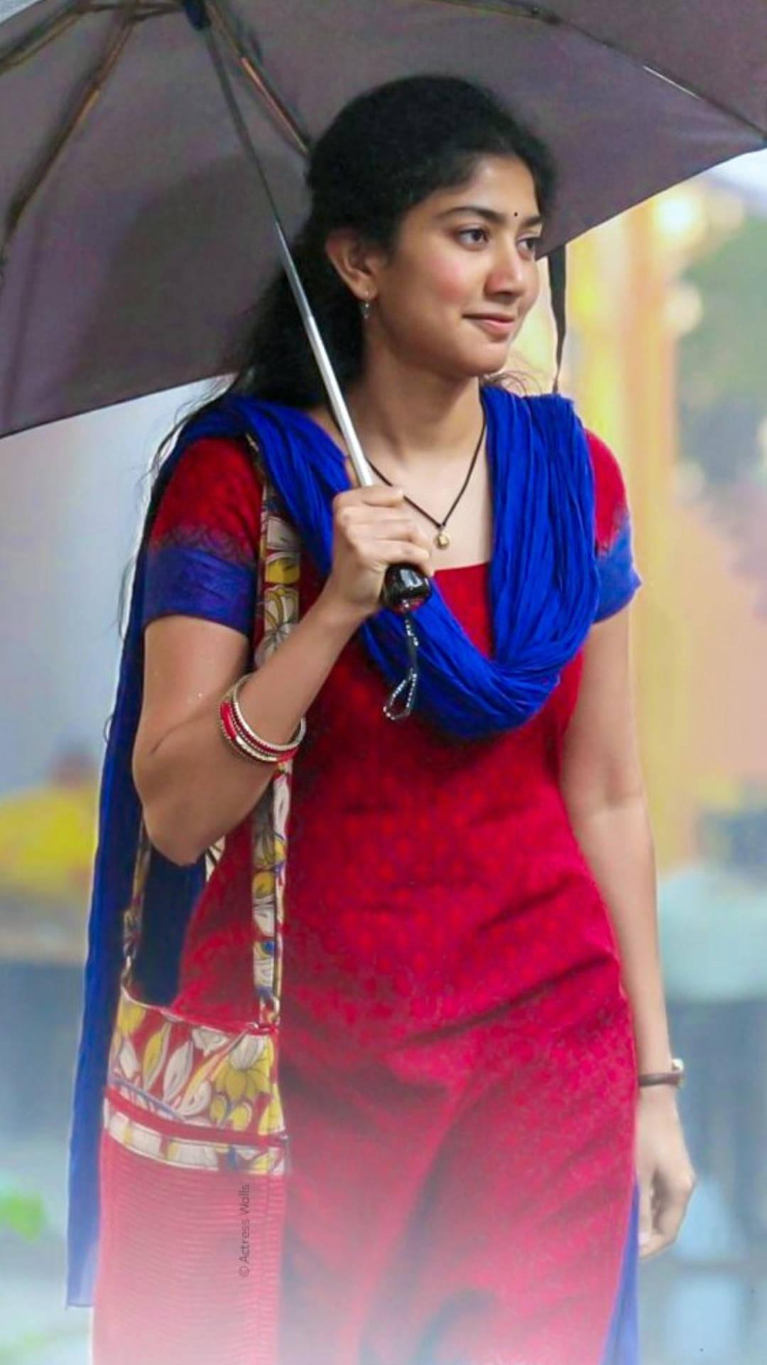 Versatile Actress Sai Pallavi Bracing the Rain with an Umbrella — 1080x1920 wallpaper