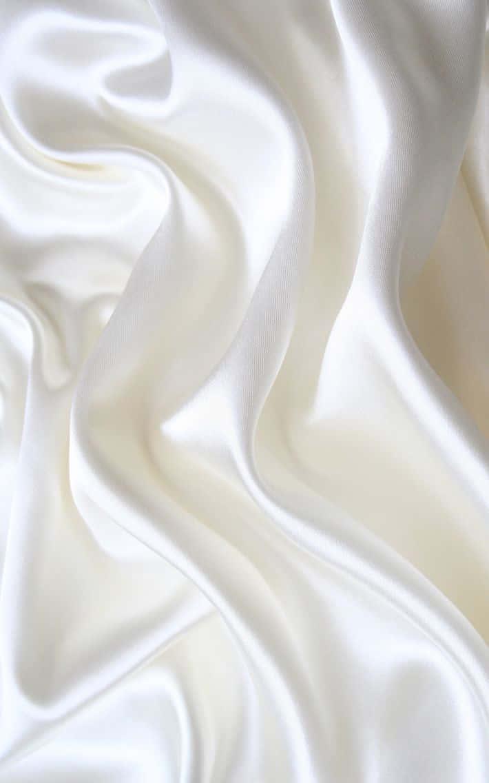 white satin fabric with a lot of folds — 710x1136 wallpaper