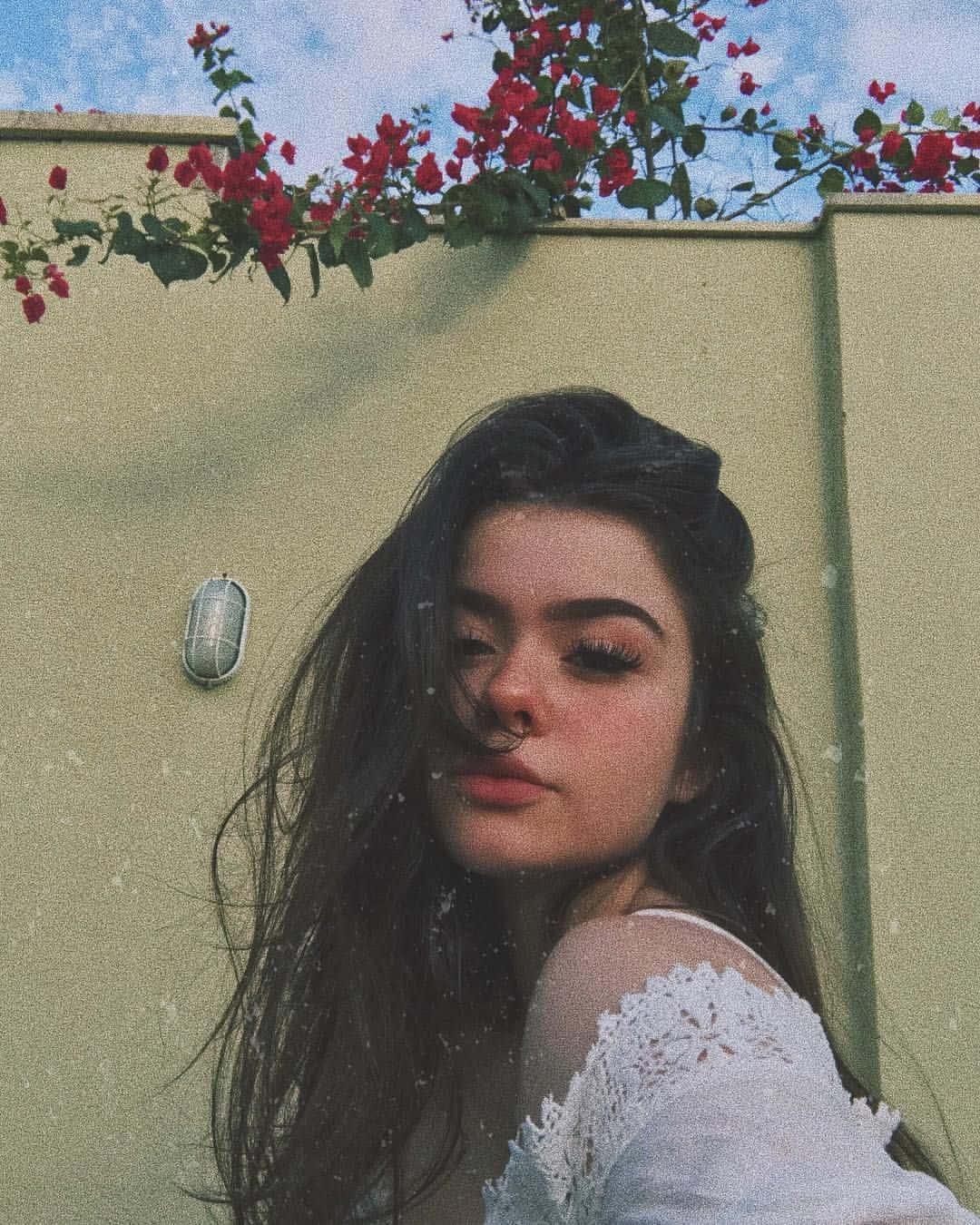 Young beautiful woman lounging in a flowers field. — 1080x1350 wallpaper